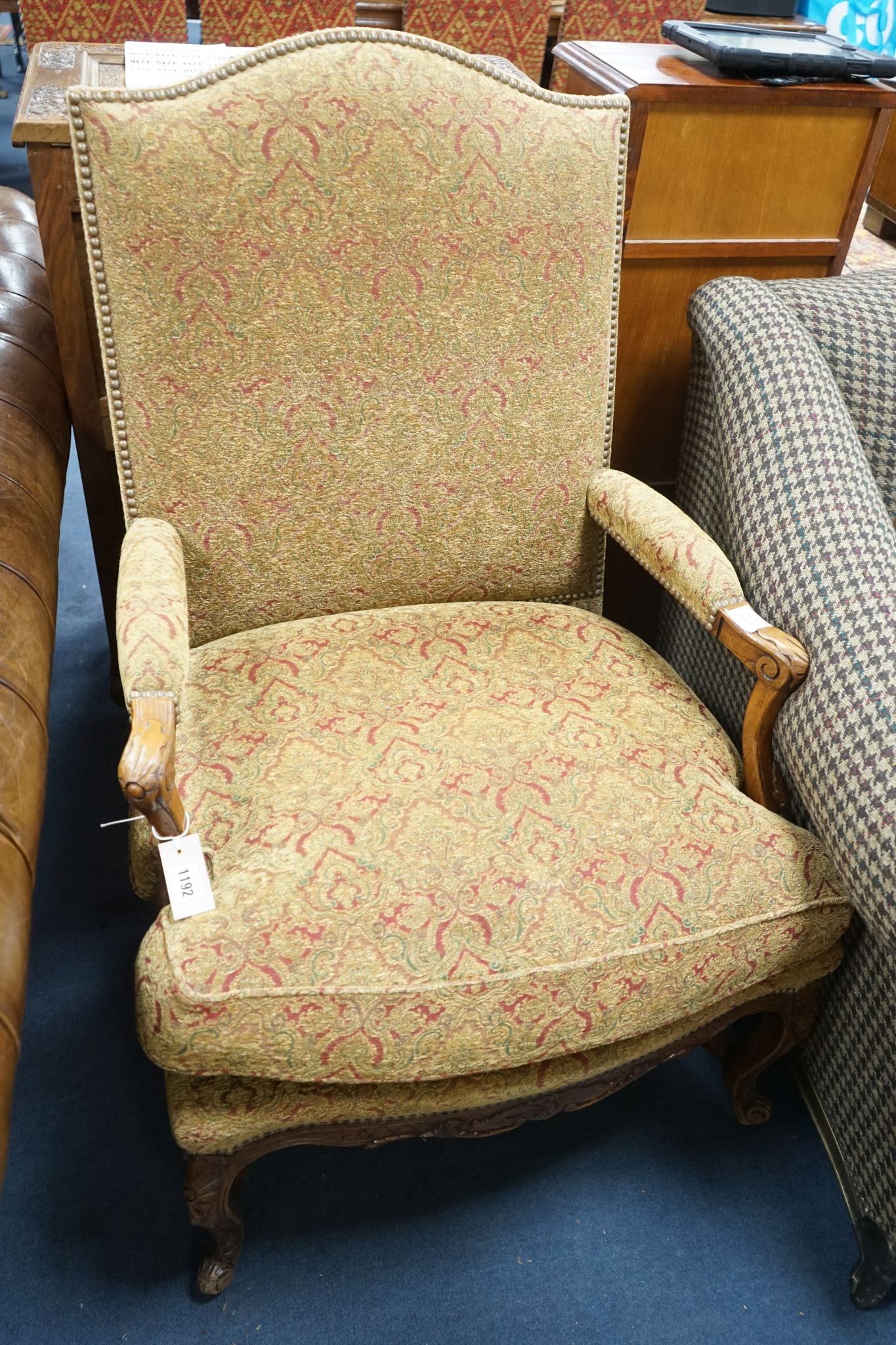 An 18th century style French walnut upholstered open armchair, width 68cm, depth 60cm, height 108cm